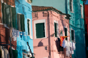 Facades of houses reflected in the water on the island of Burano in the lagoon of Venice, Italy Facades of houses reflected in the water on the island of Burano in the lagoon of Venice, Italy