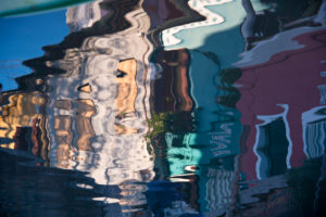 Facades of houses reflected in the water on the island of Burano in the lagoon of Venice, Italy Facades of houses reflected in the water on the island of Burano in the lagoon of Venice, Italy
