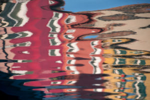 Facades of houses reflected in the water on the island of Burano in the lagoon of Venice, Italy Facades of houses reflected in the water on the island of Burano in the lagoon of Venice, Italy
