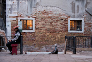 Gondolier is waiting for customers in Venice, Italy Gondolier is waiting for customers in Venice, Italy