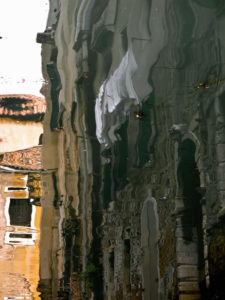 Water reflection in a canal in Venice, Italy Water reflection in a canal in Venice, Italy