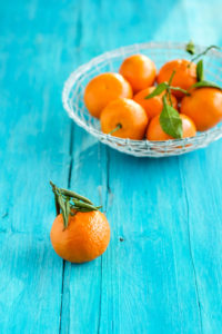 Still life with tangerines on a turquoise-blue wooden table Still life with tangerines on a turquoise-blue wooden table