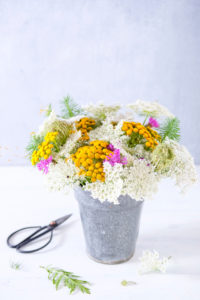 Summer bouquet of meadow flowers in a small zinc vase Summer bouquet of meadow flowers in a small zinc vase