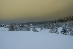 Atmospheric winter landscape in the Ore mountains with a dramatic sky Atmospheric winter landscape in the Ore mountains with a dramatic sky