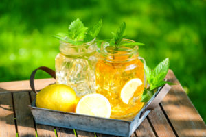 Tray with homemade iced tea on a garden table Tray with homemade iced tea on a garden table