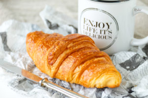 Small breakfast with croissant and coffee Small breakfast with croissant and coffee
