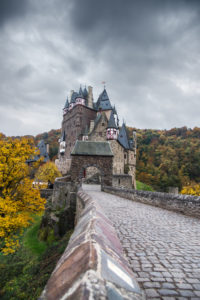 The autumnal castle Eltz in cloudy sky. The autumnal castle Eltz in cloudy sky.