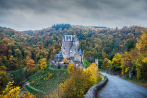 Frontal view, Burg Eltz, autumnal Eifel landscape with dark clouds. Frontal view, Burg Eltz, autumnal Eifel landscape with dark clouds.