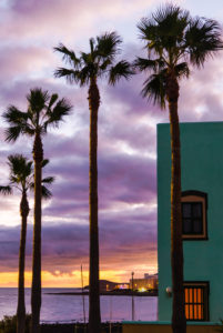 Holiday villa with palm trees in front of evening sky at sunset overlooking the sea. Holiday villa with palm trees in front of evening sky at sunset overlooking the sea.