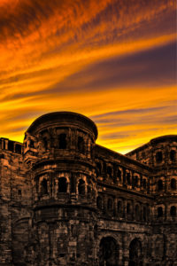 The Porta Nigra in Trier with glowing red evening sky The Porta Nigra in Trier with glowing red evening sky