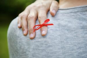 Red ribbon tied on index finger Red ribbon tied on index finger
