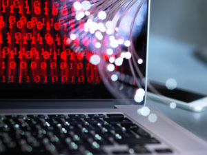 Fibre optics carrying data attacking a laptop computer which has a virus Fibre optics carrying data attacking a laptop computer which has a virus