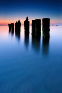 Sunset on the western beach, stone pyramids on old groyne, Darß, Baltic Sea, Mecklenburg-Vorpommern, Germany Sunset on the western beach, stone pyramids on old groyne, Darß, Baltic Sea, Mecklenburg-Vorpommern, Germany