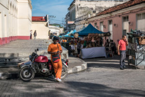 Tourist market in Santa Clara, waiting man with motorcycle and side car, Cuba Tourist market in Santa Clara, waiting man with motorcycle and side car, Cuba