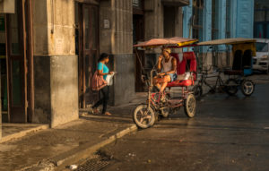 Rickshaw driver waiting for customers in Havana, Cuba Rickshaw driver waiting for customers in Havana, Cuba