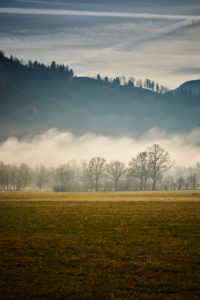 morning fog and autumn mood in front the Sonntratn in Gaißach, Bavaria, in November                              