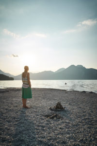 Woman at sundown in the back light in summer in the Walchensee, Bavaria