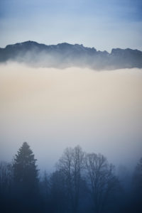 Over the clouds on the Sonntratn near Gaißach in Bavaria, chilly autumn mood, valley in the fog, mountains over the clouds