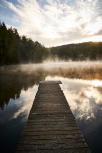 Late-summery morning mood with deep early fog over the forest pond in Dietramszell, Bavaria