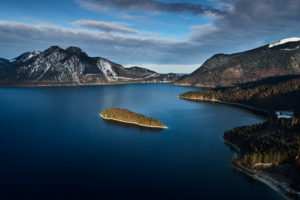Drone recording of Walchensee in Bavaria, Germany, the first snow on the trees, November in the Walchensee