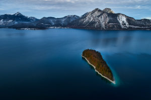 Drone recording of Walchensee in Bavaria, Germany, the first snow on the trees, November in the Walchensee
