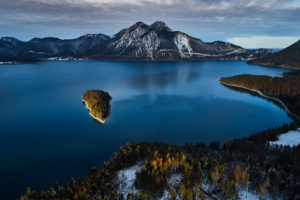 Drone recording of Walchensee in Bavaria, Germany, the first snow on the trees, November in the Walchensee