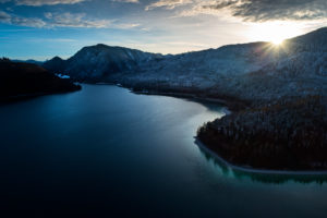 Drone recording of Walchensee in Bavaria, Germany, the first snow on the trees, November in the Walchensee