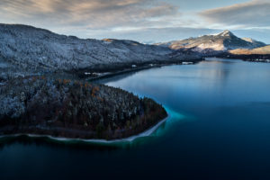 Drone recording of Walchensee in Bavaria, Germany, the first snow on the trees, November in the Walchensee