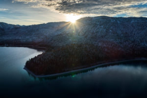 Drone recording of Walchensee in Bavaria, Germany, the first snow on the trees, November in the Walchensee