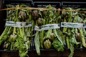 Artichokes are offered at a market in bunches, Bosa, Sardinia, Italy Artichokes are offered at a market in bunches, Bosa, Sardinia, Italy