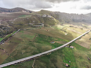 A highway winds its way through the wild landscape in the hinterland of Palermo, Sicily, Italy.