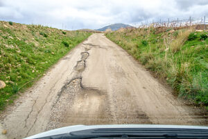 View from the cockpit of a camper on a narrow and very bad, dilapidated country road. Sicily, Italy.