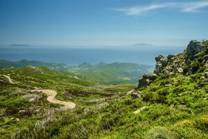 A gravel road leads over the Cap Corse through wild countryside, Corsica, France A gravel road leads over the Cap Corse through wild countryside, Corsica, France