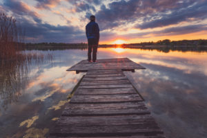Europe, Germany, Bavaria, Breitbrunn, Chiemsee, Chiemgau, Chiemsee Lake, Man standing on jetty and looking into sunset, Europe, Germany, Bavaria, Breitbrunn, Chiemsee, Chiemgau, Chiemsee Lake, Man standing on jetty and looking into sunset,