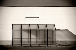 Empty plastic shelter for shopping carts on the wall of a shopping centre, Empty plastic shelter for shopping carts on the wall of a shopping centre,