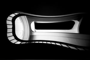 The low angle view of a stairway with a spiral staircase and railing The low angle view of a stairway with a spiral staircase and railing