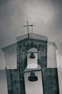 The bell tower of an old church with a free hanging bell. The bell tower of an old church with a free hanging bell.