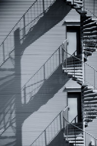A spiral staircase, fire escape, side view facade of an industrial building. A spiral staircase, fire escape, side view facade of an industrial building.