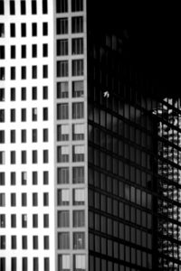 The modern facade of a high rise with reflections in the windows. The modern facade of a high rise with reflections in the windows.
