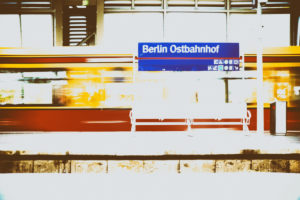 A platform of the Berlin Ostbahnhof with a grid bench and an incoming streetcar in Berlin. A platform of the Berlin Ostbahnhof with a grid bench and an incoming streetcar in Berlin.