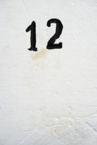 the number twelve on a stone, black and white