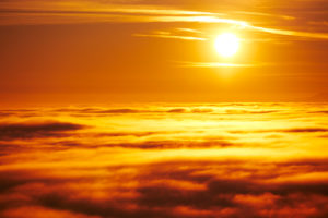 Evening mood, sun in the backlight, clouds and haze,