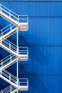 white fire escape on a blue facade white fire escape on a blue facade