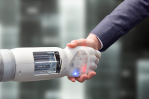 Robot shakes hands with a man Robot shakes hands with a man