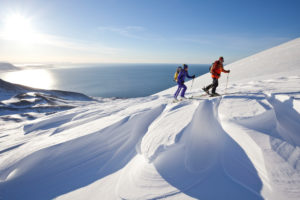 Two mountaineers on ski tour in Akureyri, Fjord Eyjafjördur, Nordland, Iceland Two mountaineers on ski tour in Akureyri, Fjord Eyjafjördur, Nordland, Iceland