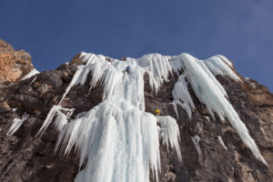 Waterfall ice climbing in winter in Langental, Val Gardena, Dolomites, Italy