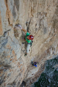 Climber in the rock faces of Monte Monaco at Capo San Vito, Sicily, Italy