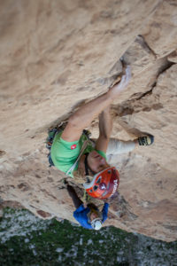 Climber in the rock faces of Monte Monaco at Capo San Vito, Sicily, Italy