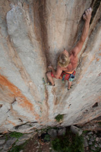 Climber in the rock faces of Monte Monaco at Capo San Vito, Sicily, Italy