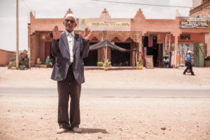 Old man gesturing at the camera, wrinkled face, broadcasting, Morocco, Ouarzazate Old man gesturing at the camera, wrinkled face, broadcasting, Morocco, Ouarzazate